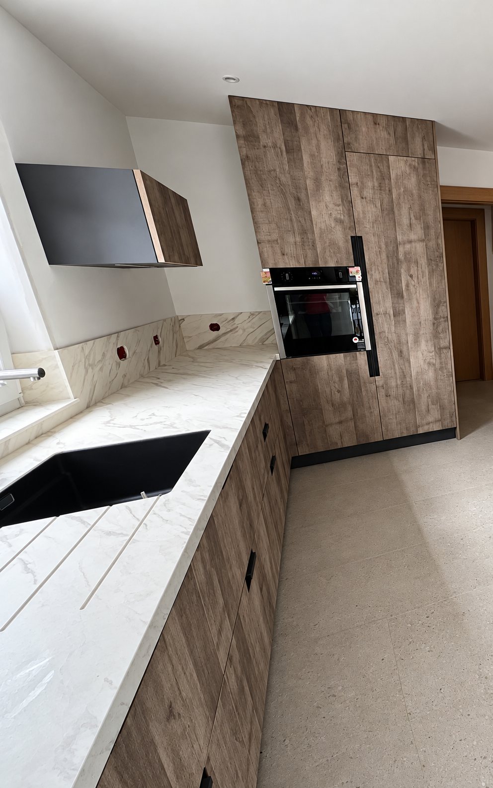 Cuisine moderne avec façades façon bois et plan de travail effet marbre
